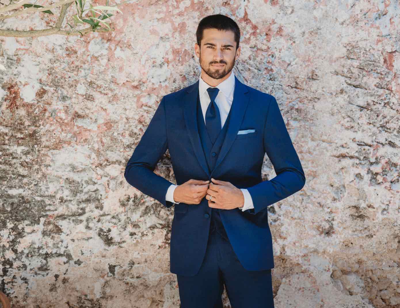 Male model wearing a dark blue tuxedo