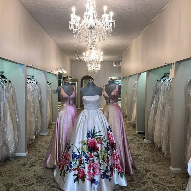 Three evening dresses shown in J & B Bridals & Tuxedos show room